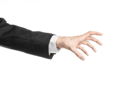 Businessman and gesture topic: a man in a black suit and white shirt showing hand gesture on an isolated white background in studio