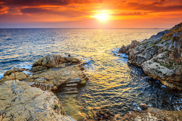 Stunning rocky beach and beautiful sunset near Rovinj,Istria,Croatia