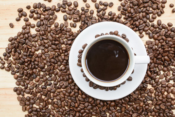 arabica coffee beans and cup full of coffee