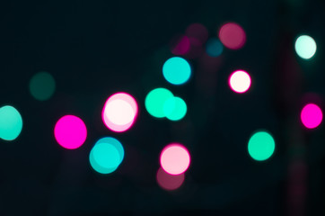 Abstract blurred background and theme: colorful bokeh blurred lights on a dark background