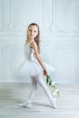 A little adorable young ballerina in a playful mood in the inter © jutaphoto