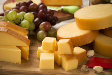 Different cheeses on a cutting board, delicious food