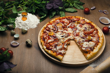 delicious pizza in composition with fresh vegetables