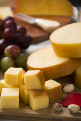 Different cheeses on a cutting board, delicious food