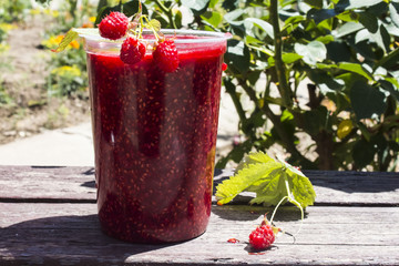 in a glass of fresh raspberry jam with berries