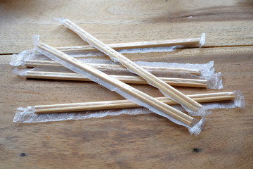 package of readymade bamboo chopsticks on wooden background