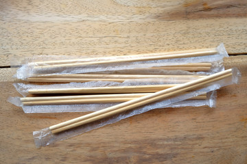 package of readymade bamboo chopsticks on wooden background