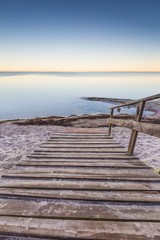 Landscape with wooden stairs leading to the sea © milosz_g