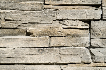 Decorative relief cladding slabs imitating stones on wall