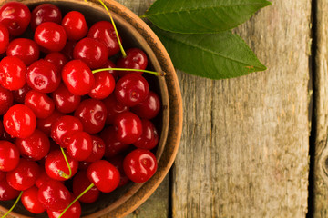 Cherries on wooden table with water drops macro background