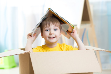 kid boy playing in a toy house in nursery © Oksana Kuzmina