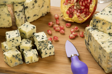 Different cheeses on a cutting board, delicious food