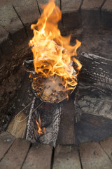 Popcorn in a foil covered pan explodes and catches fire in a garden fire pit