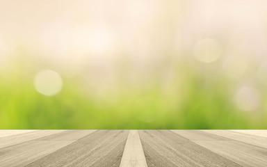 Green abstract blur nature background with wooden floor