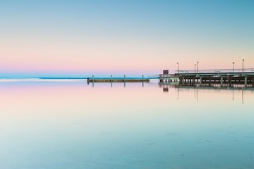 Fototapeta na wymiar Beautiful wooden pier on Baltic sea shore