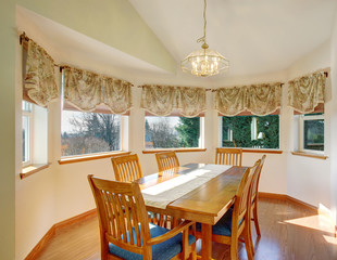 Simple dinning room with hardwood floor and chairs.