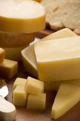 Different cheeses on a cutting board, delicious food