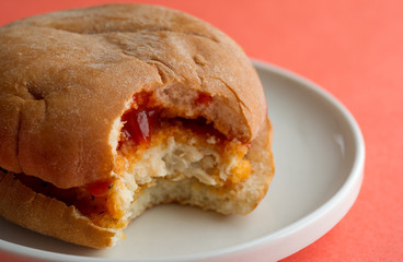 Close view of a bitten chicken sandwich