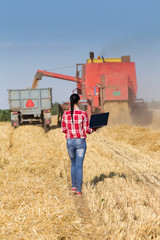 Young woman in wheat field during harvest