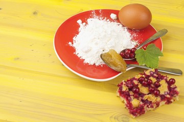 Ingredients for domestic production currant dessert. Flour, eggs, honey and red currants. Chef prepares the ingredients to bake a dessert.
