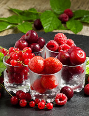 Assorted summer berries: raspberries, red currant, cherry, straw