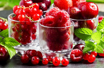 Assorted summer berries: raspberries, red currant, cherry, straw
