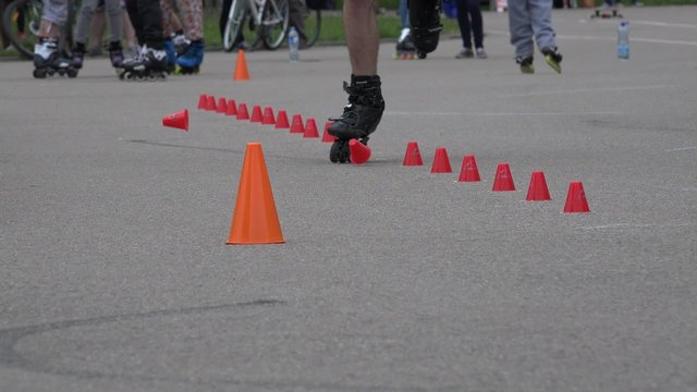 roller skater man foot ride on one wheel spin slalom. Active sport. Static closeup shot. 4K
