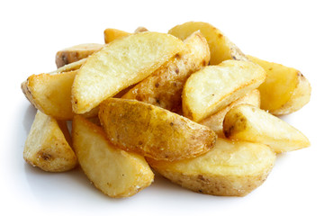 Heap of fried potato wedges isolated on white.