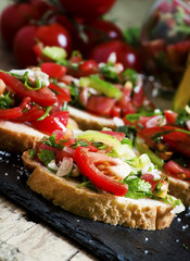 Italian bruschetta with tomato, onion and bell pepper, selective