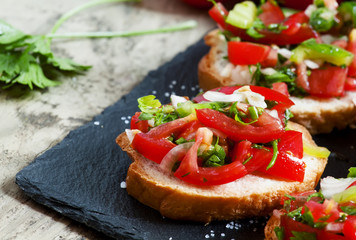 Italian bruschetta with tomato, onion and bell pepper, selective