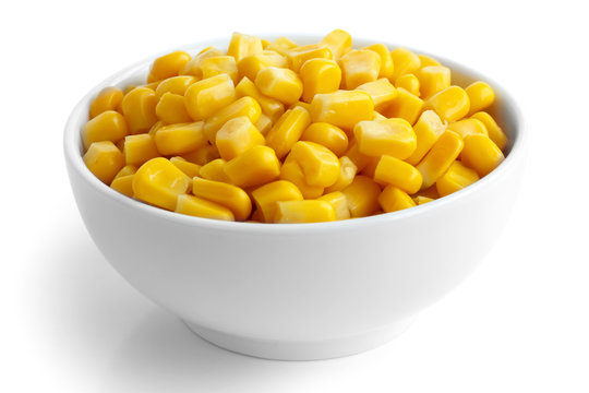 Bowl of tinned sweetcorn isolated on white.
