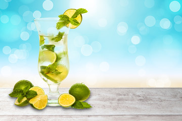 water or cocktail with a blurred beach background