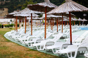 Beach umbrellas at the hotel lounge chairs