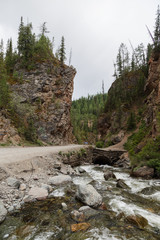 Mountain road among the rocks of river