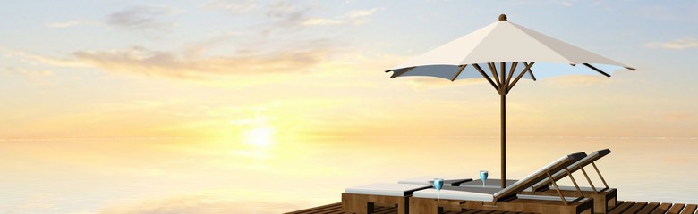Fototapeta na wymiar Deck Chairs and umbrella in sunset on the beach