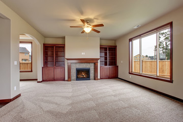 Lovely unfurnished living room with carpet.
