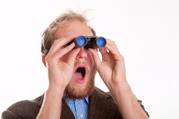 Shocked man watching through binoculars