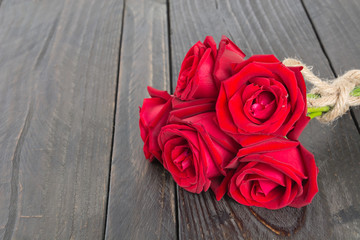 red rose bouquet on wood background