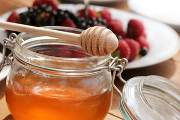 Honey glass,wooden dipper,fruits