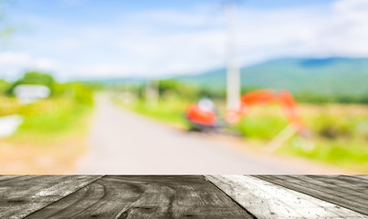 blur image of orange excavator doing road construction.