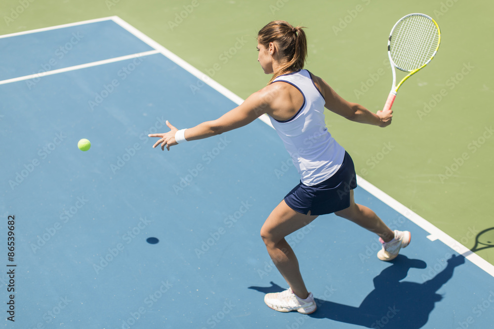 Wall mural young woman playing tennis