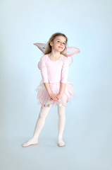 Naklejka premium Cute girl in fairy costume posing in the studio