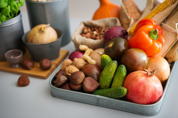Closeup of Autumn fruits, vegetables, nuts on kitchen counter