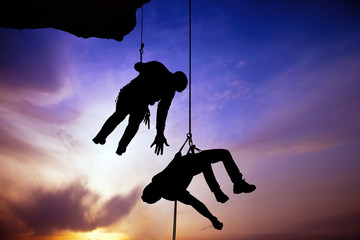 Silhouette of helping hand between two climber