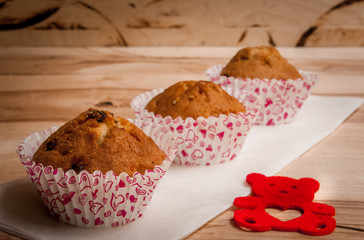 Blank instant photo hanging on rope with lovely hearts, cute teddy bear with the word love on rustic wooden wall.