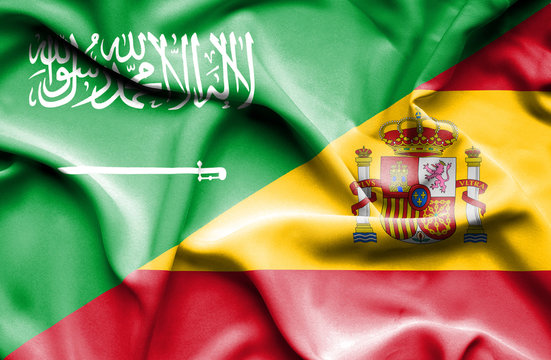 Waving flag of Spain and Saudi Arabia