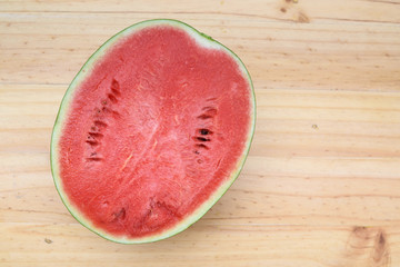 half watermelon with wood table background