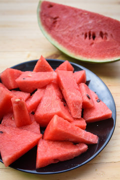 sliced watermelon on plate with wood table
