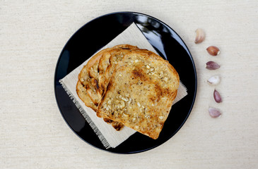Garlic bread on black plate design background