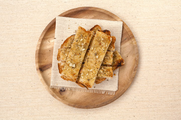 Garlic bread on wooden plate 
